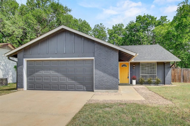 6603 Krollton Dr, Austin, TX 78745 - view of front of property with board and batten siding, brick siding, concrete driveway, and an attached garage
