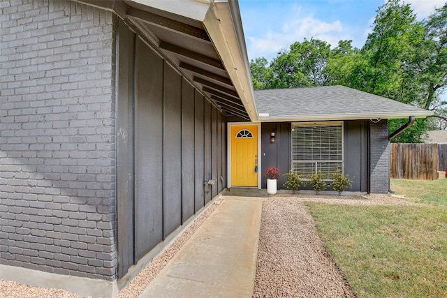6603 Krollton Dr, Austin, TX 78745 - property entrance featuring board and batten siding, brick siding, and a shingled roof