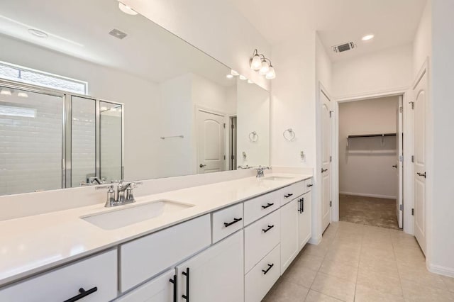 169 Slenderleaf Dr, Marble Falls, TX 78654 - full bath featuring a stall shower, double vanity, tile patterned flooring, baseboards, and recessed lighting