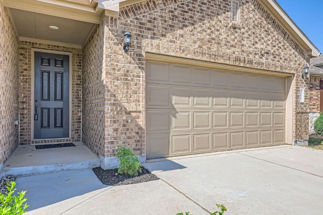 169 Slenderleaf Dr, Marble Falls, TX 78654 - entrance to property with brick siding, a garage, and concrete driveway