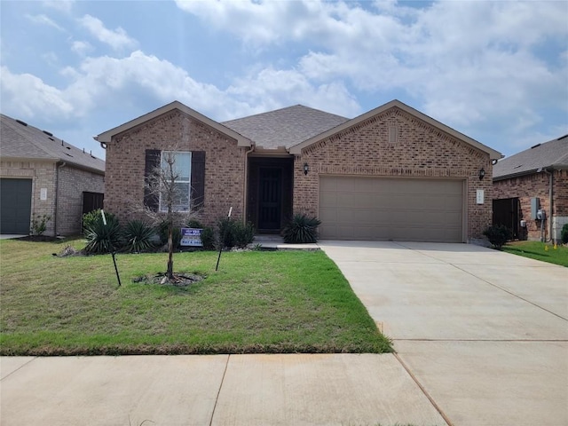 169 Slenderleaf Dr, Marble Falls, TX 78654 - view of front of house with brick siding, an attached garage, driveway, and a front yard