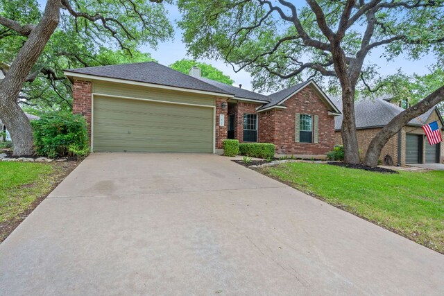 8104 Isaac Pryor Dr, Austin, TX 78749 - view of front of property featuring an attached garage, brick siding, driveway, and a front lawn