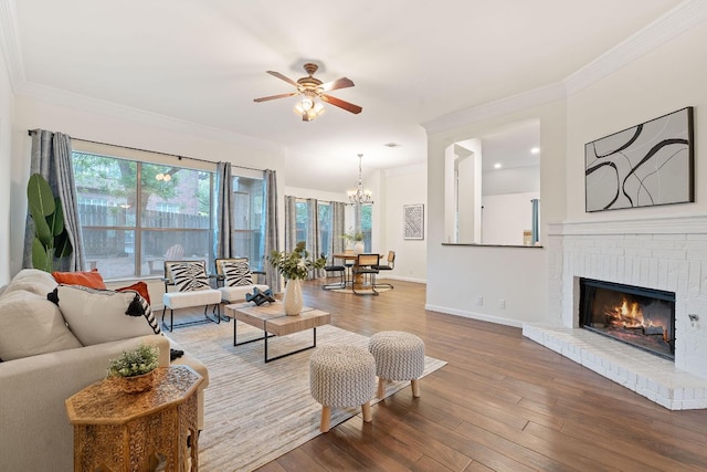 8104 Isaac Pryor Dr, Austin, TX 78749 - living room with wood finished floors, ornamental molding, baseboards, a fireplace, and ceiling fan with notable chandelier