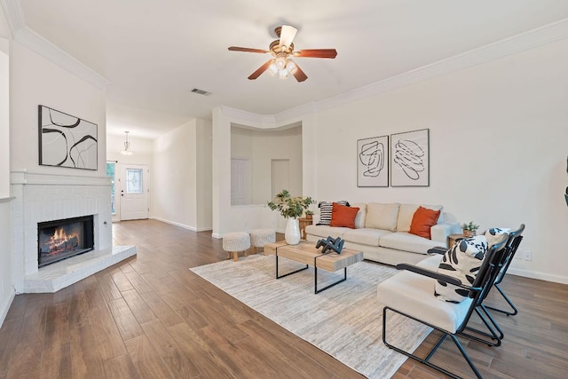 8104 Isaac Pryor Dr, Austin, TX 78749 - living area with a ceiling fan, dark wood-type flooring, crown molding, and a fireplace