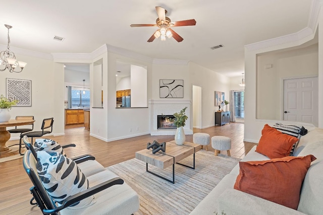 8104 Isaac Pryor Dr, Austin, TX 78749 - living room featuring visible vents, light wood finished floors, baseboards, and ceiling fan with notable chandelier