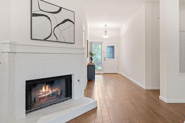 8104 Isaac Pryor Dr, Austin, TX 78749 - entryway with baseboards, wood finished floors, and a fireplace