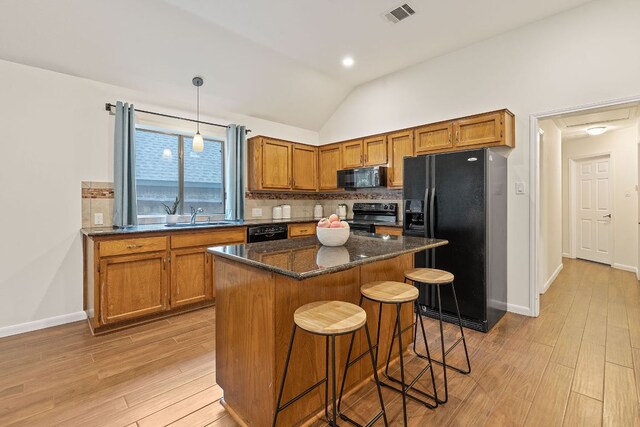8104 Isaac Pryor Dr, Austin, TX 78749 - kitchen with a sink, black appliances, light wood-style floors, backsplash, and visible vents