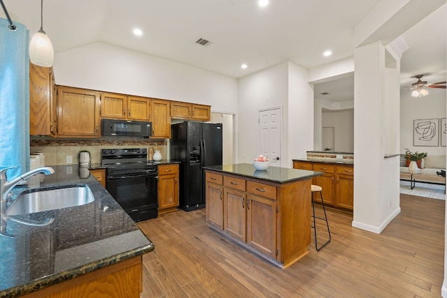 8104 Isaac Pryor Dr, Austin, TX 78749 - kitchen featuring tasteful backsplash, a sink, black appliances, brown cabinets, and visible vents