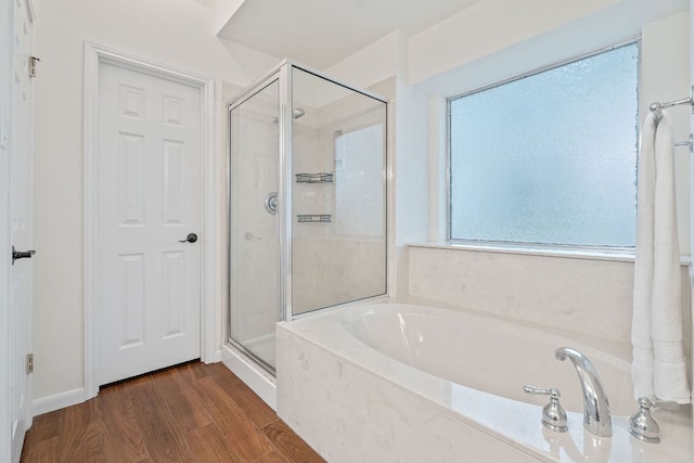 8104 Isaac Pryor Dr, Austin, TX 78749 - bathroom with a shower stall, a garden tub, and wood finished floors