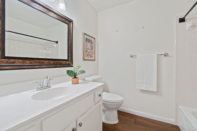 8104 Isaac Pryor Dr, Austin, TX 78749 - bathroom featuring wood finished floors, shower / bathtub combination, toilet, vanity, and baseboards