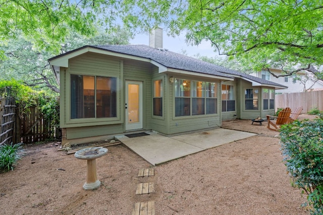 8104 Isaac Pryor Dr, Austin, TX 78749 - back of house with a chimney, a patio, and fence