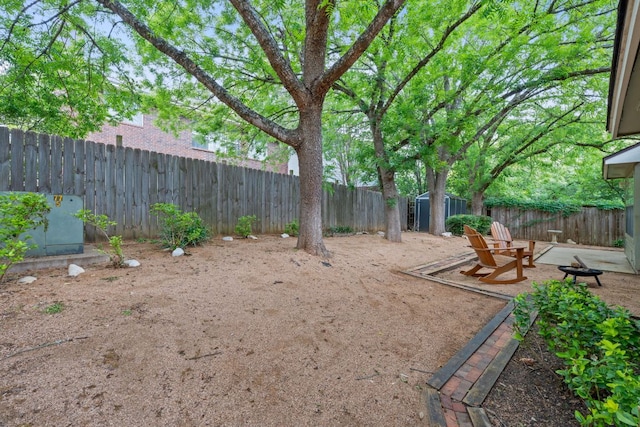 8104 Isaac Pryor Dr, Austin, TX 78749 - view of yard with a fenced backyard and a fire pit