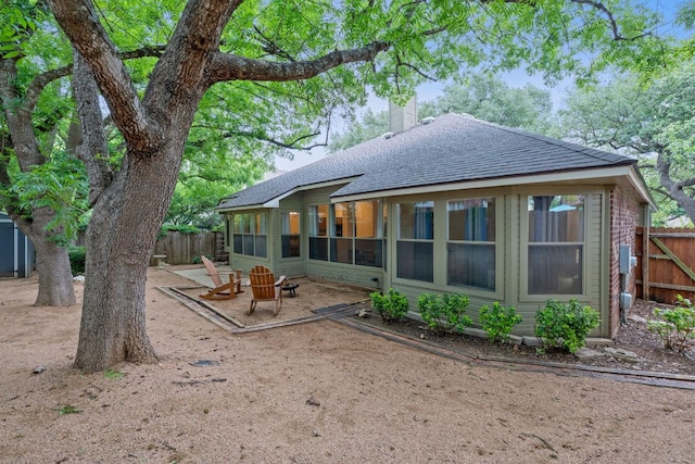 8104 Isaac Pryor Dr, Austin, TX 78749 - back of property with fence, a chimney, roof with shingles, and a patio
