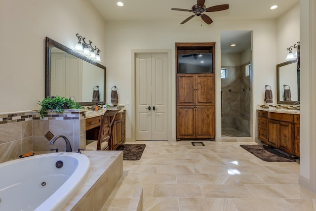 full bath featuring a stall shower, ceiling fan, a jetted tub, two vanities, and recessed lighting