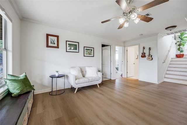 20718 Camel Back St, Lago Vista, TX 78645 - living area featuring wood finished floors, stairway, crown molding, a ceiling fan, and baseboards