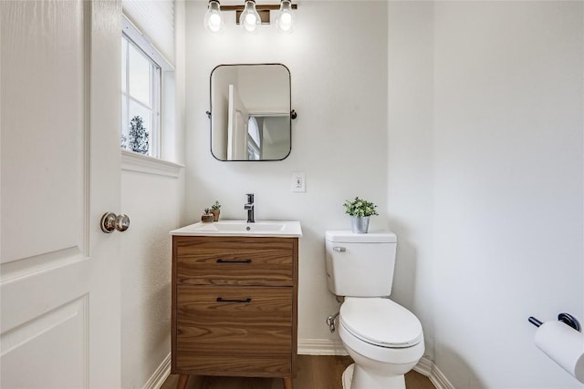 20718 Camel Back St, Lago Vista, TX 78645 - bathroom featuring toilet, vanity, wood finished floors, and baseboards