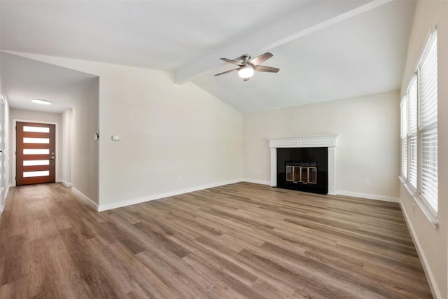 11932 Shropshire Blvd, Austin, TX 78753 - unfurnished living room with a ceiling fan, wood finished floors, a fireplace with flush hearth, and baseboards