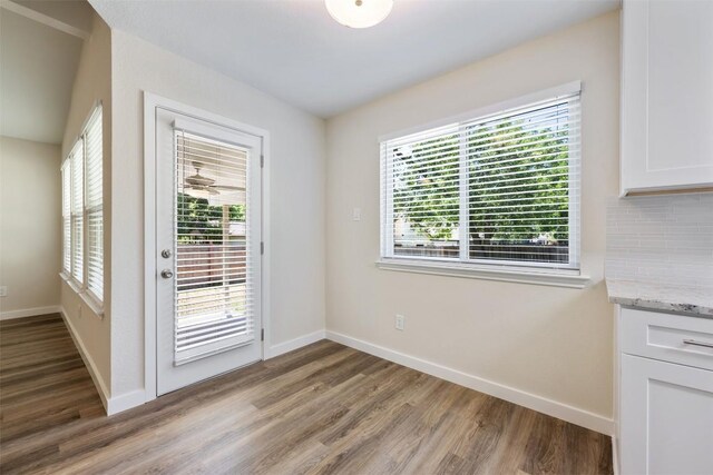 entryway with wood finished floors and baseboards