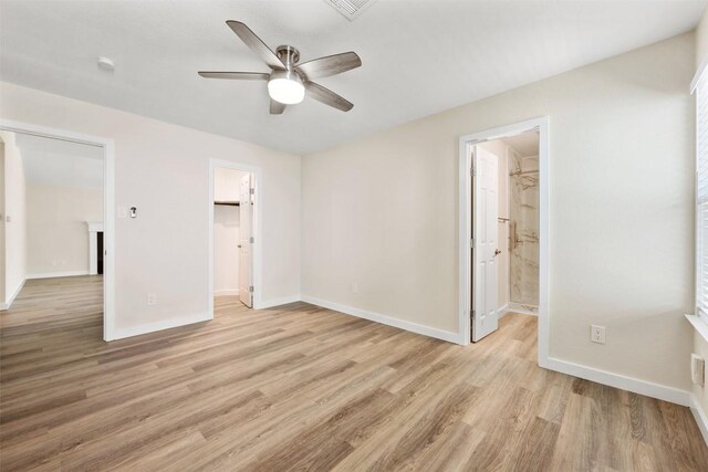 11932 Shropshire Blvd, Austin, TX 78753 - unfurnished bedroom featuring light wood-type flooring, baseboards, a spacious closet, ceiling fan, and ensuite bathroom