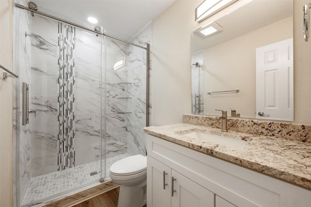 11932 Shropshire Blvd, Austin, TX 78753 - bathroom with toilet, vanity, a marble finish shower, and wood finished floors