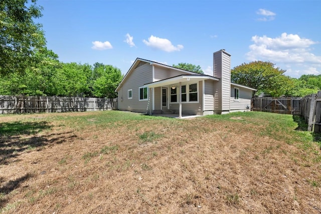 11932 Shropshire Blvd, Austin, TX 78753 - rear view of property featuring a chimney and a patio