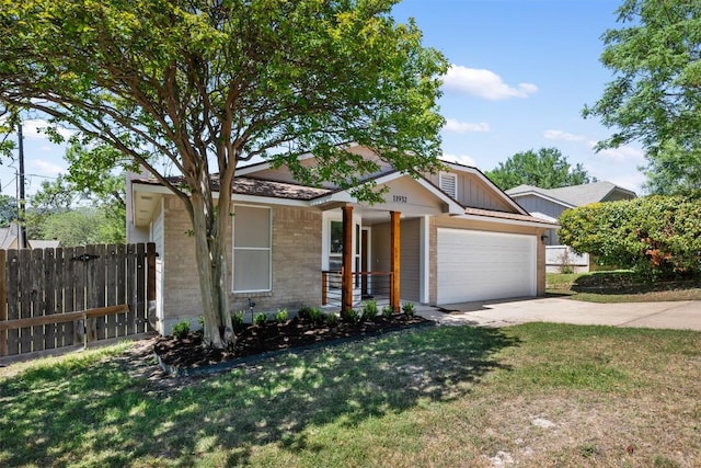 11932 Shropshire Blvd, Austin, TX 78753 - view of front facade featuring a garage, concrete driveway, brick siding, and board and batten siding