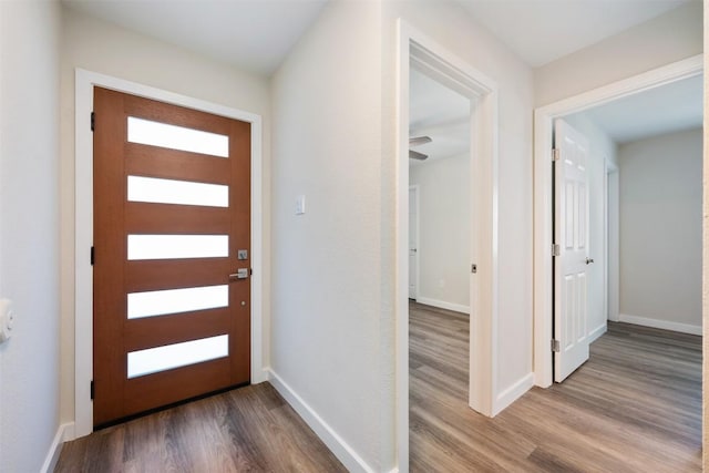 entryway featuring baseboards and wood finished floors