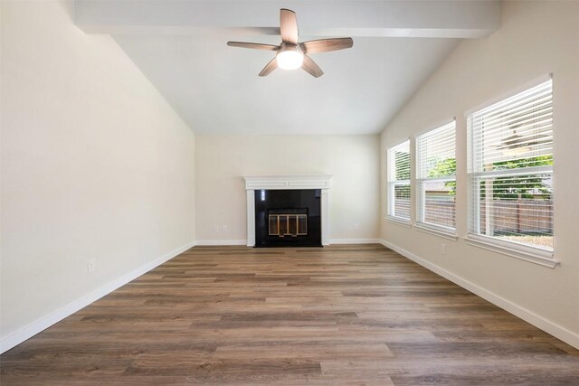 unfurnished living room with lofted ceiling, a tiled fireplace, wood finished floors, and ceiling fan