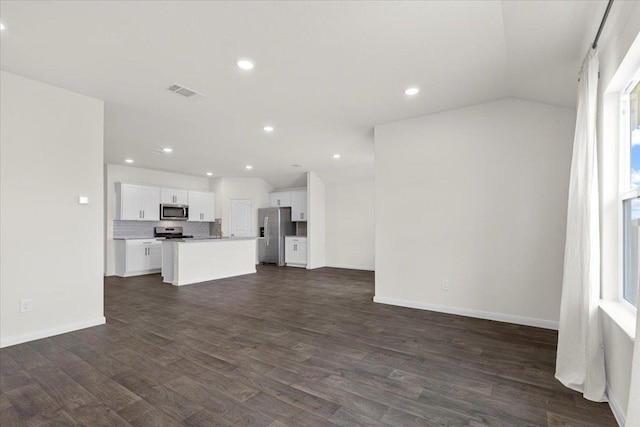 136 Medinah Ln, San Marcos, TX 78666 - unfurnished living room with baseboards, dark wood-type flooring, and recessed lighting