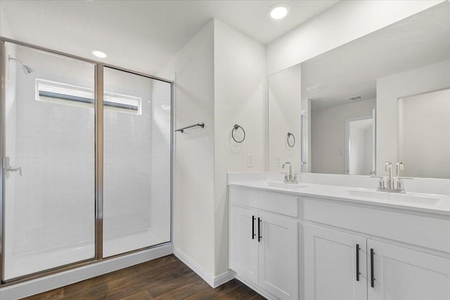 136 Medinah Ln, San Marcos, TX 78666 - full bath featuring double vanity, wood finished floors, a stall shower, and a sink