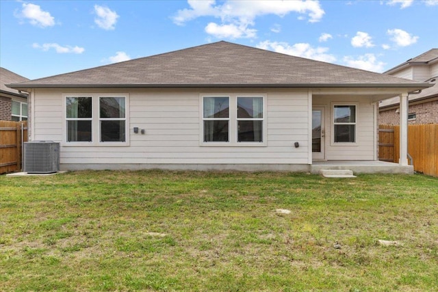 136 Medinah Ln, San Marcos, TX 78666 - rear view of property with a lawn, a fenced backyard, and central AC unit