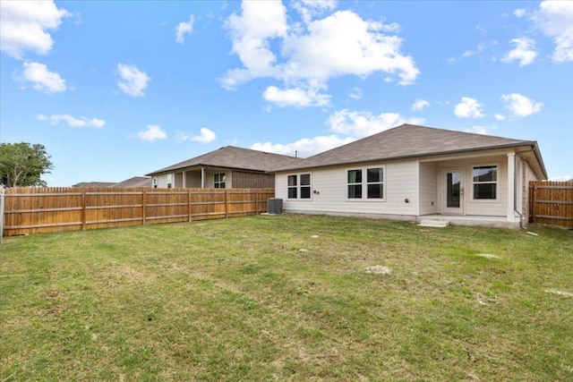 136 Medinah Ln, San Marcos, TX 78666 - back of house with a fenced backyard, central air condition unit, and a lawn
