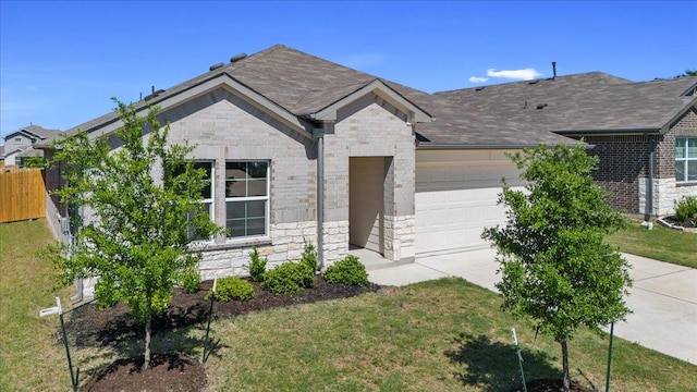 136 Medinah Ln, San Marcos, TX 78666 - single story home with fence, concrete driveway, an attached garage, stone siding, and roof with shingles