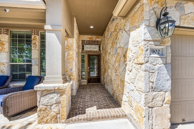 doorway to property featuring stone siding and covered porch