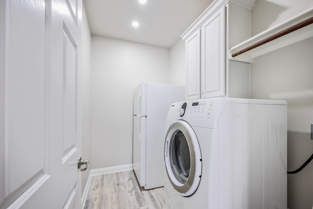 laundry room with recessed lighting, washer / dryer, light wood-type flooring, baseboards, and cabinet space