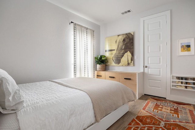 bedroom with visible vents and light wood-style flooring