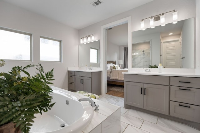 full bathroom with a bath, two vanities, a sink, tiled shower, and visible vents