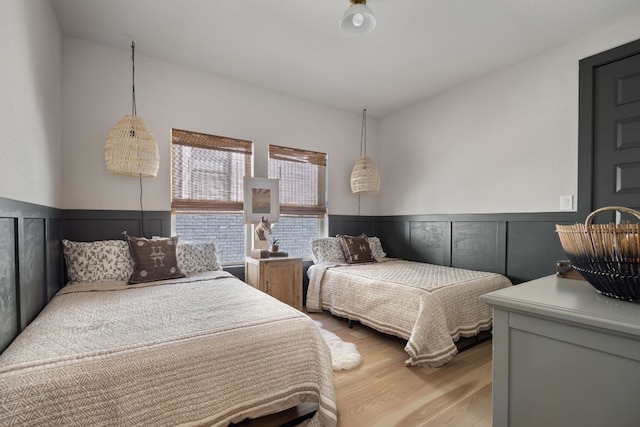 229 S Park Vis, Georgetown, TX 78628 - bedroom with light wood-style flooring and a wainscoted wall