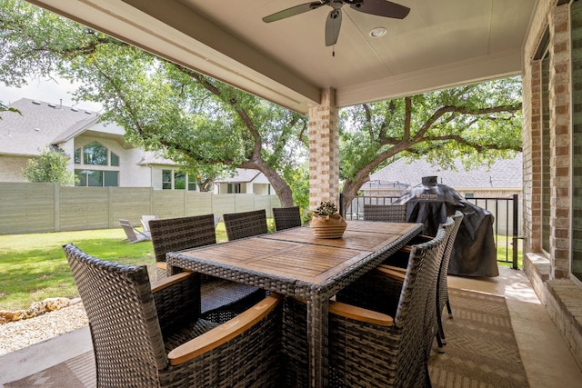 view of patio / terrace featuring outdoor dining area, a ceiling fan, and a fenced backyard