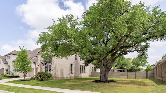 exterior space with fence and a front yard