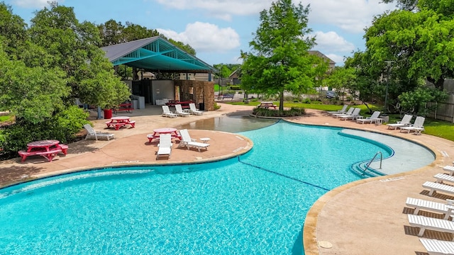 community pool featuring a gazebo, a patio area, and fence