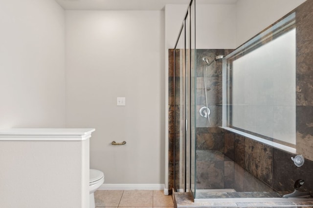 full bath with a shower stall, tile patterned floors, baseboards, and toilet