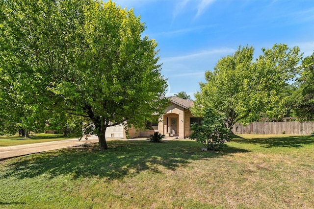 171 Calle Largo, Kyle, TX 78640 - obstructed view of property with an attached garage, fence, driveway, and a front yard
