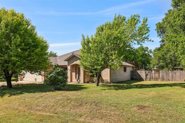 171 Calle Largo, Kyle, TX 78640 - view of front of home with fence, a front lawn, and brick siding