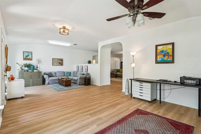 171 Calle Largo, Kyle, TX 78640 - living area featuring wood finished floors, a ceiling fan, and arched walkways