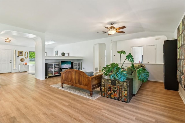 171 Calle Largo, Kyle, TX 78640 - living room with arched walkways, a ceiling fan, wood finished floors, lofted ceiling, and visible vents