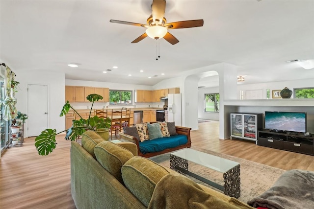 171 Calle Largo, Kyle, TX 78640 - living area with arched walkways, light wood finished floors, ceiling fan, and recessed lighting