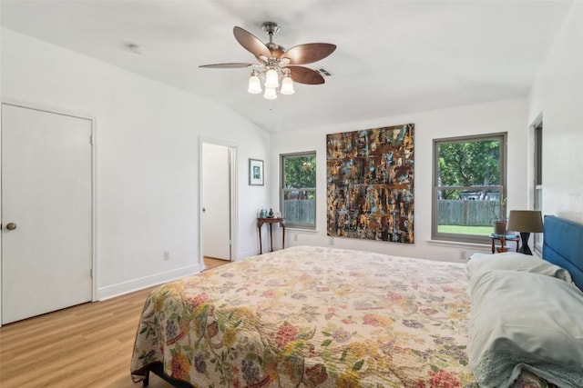 171 Calle Largo, Kyle, TX 78640 - bedroom with multiple windows, vaulted ceiling, light wood-type flooring, and ceiling fan