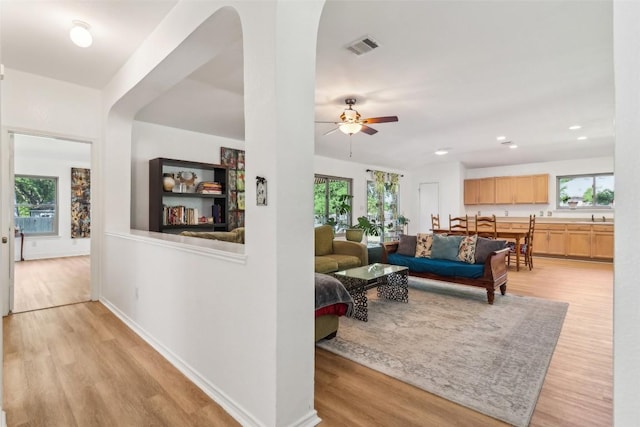171 Calle Largo, Kyle, TX 78640 - living room with light wood-style floors, plenty of natural light, a ceiling fan, and visible vents