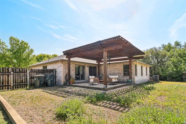 171 Calle Largo, Kyle, TX 78640 - back of property featuring central air condition unit, a pergola, a yard, and fence